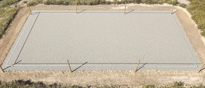 Prepared parking lot base with grade stakes, string line and measuring wheel before paving