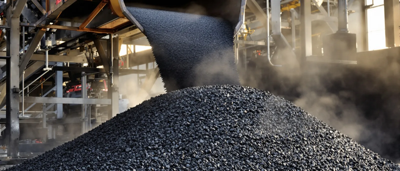 Steaming load of hot mix asphalt in a dump truck bed with the tarp partly rolled back