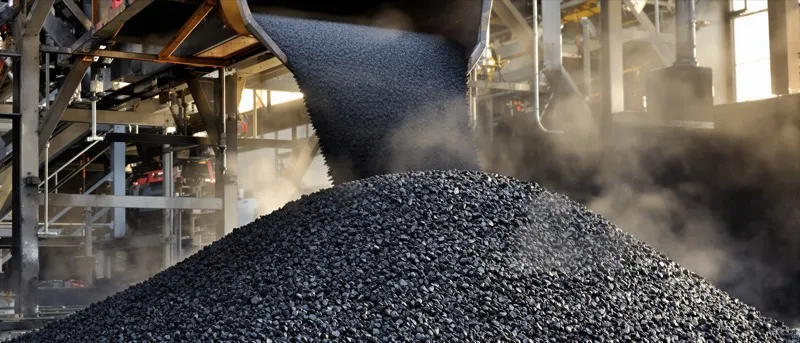 Steaming load of hot mix asphalt in a dump truck bed with the tarp partly rolled back